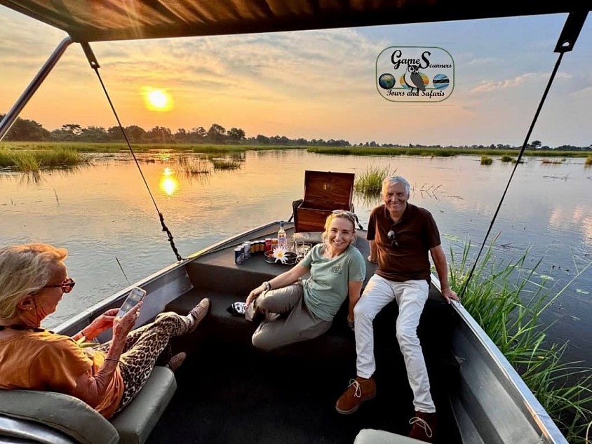 Boat cruising in the Okavango white sand channel